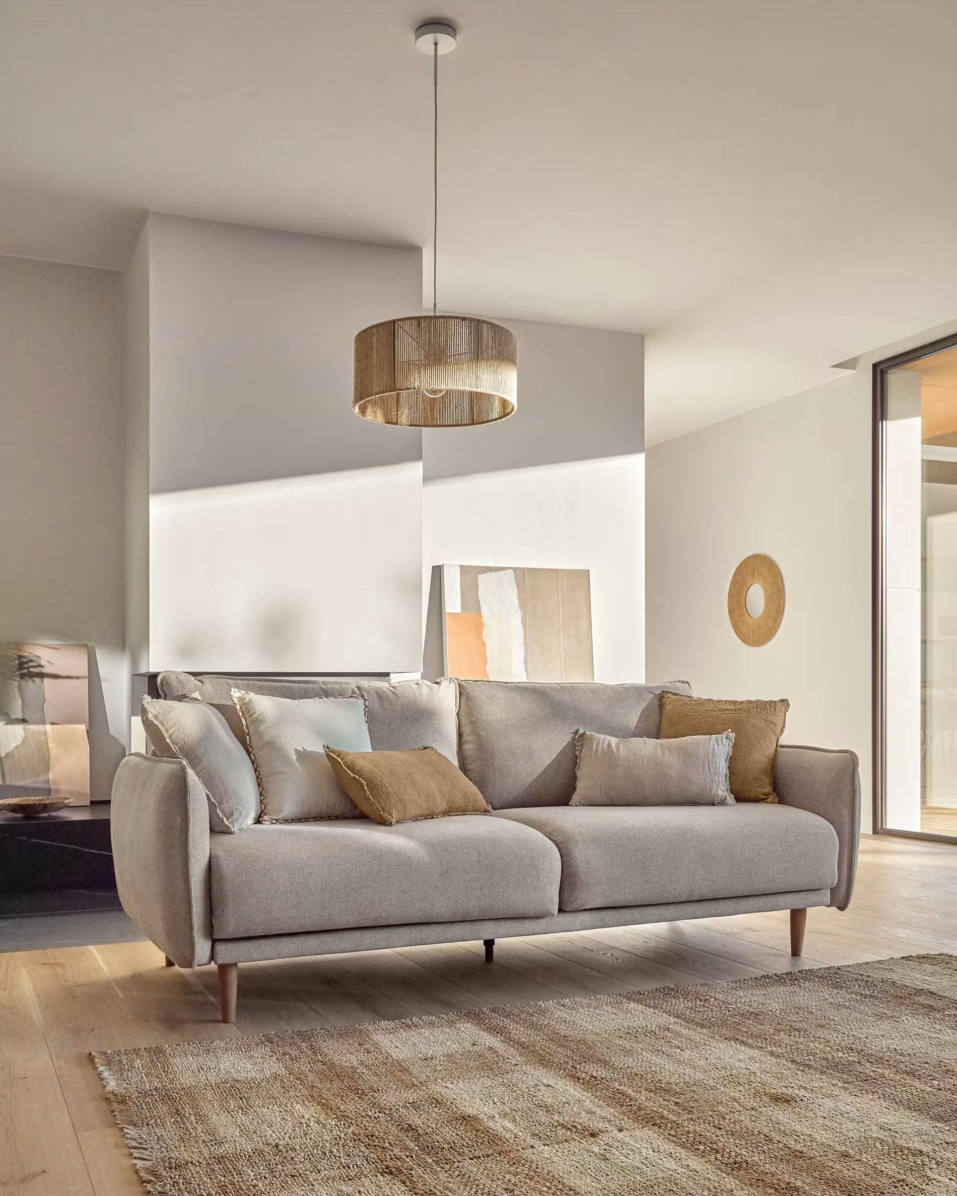Gray sofa with decorative pillows in a modern living room setting