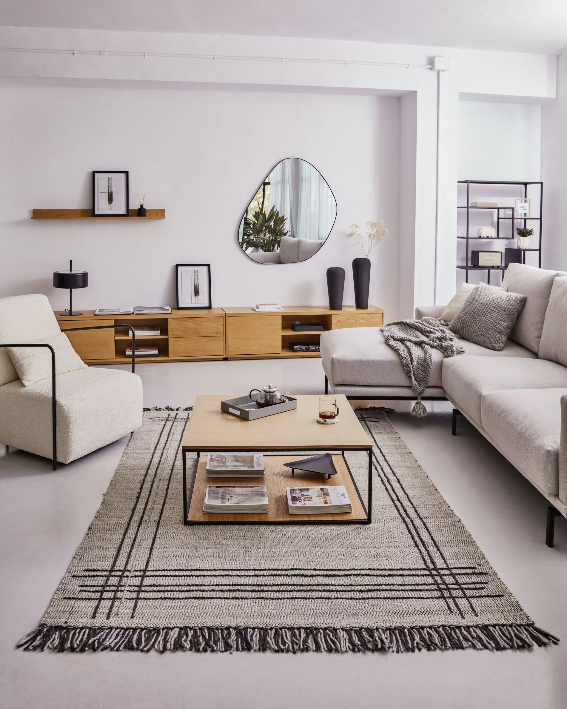 Modern living room with a rug, coffee table, and sofa.