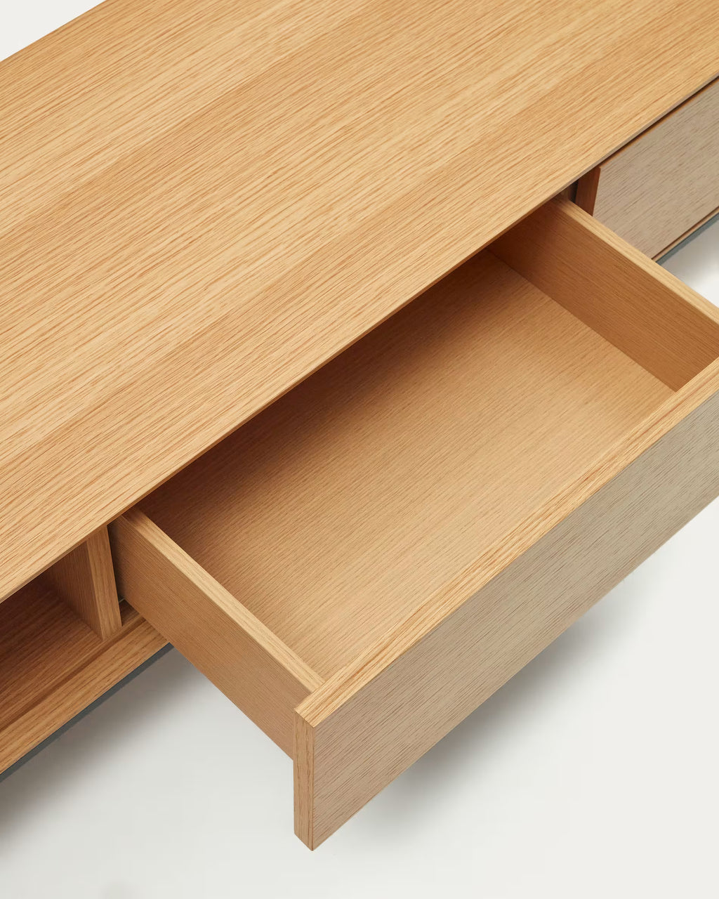 Wooden drawer open on a light wood cabinet