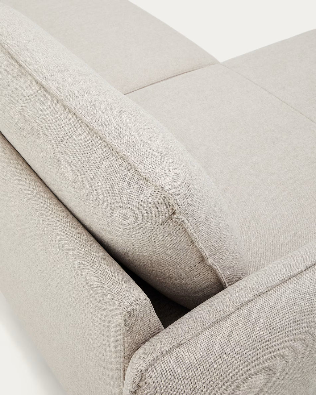 Close-up of a beige fabric sofa with visible stitching on a white background