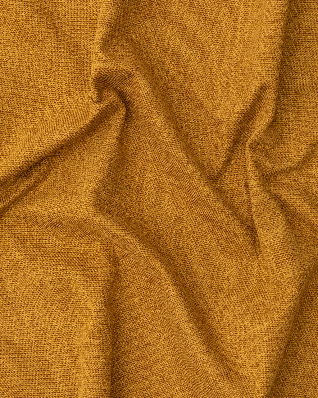 Close-up of textured mustard yellow fabric