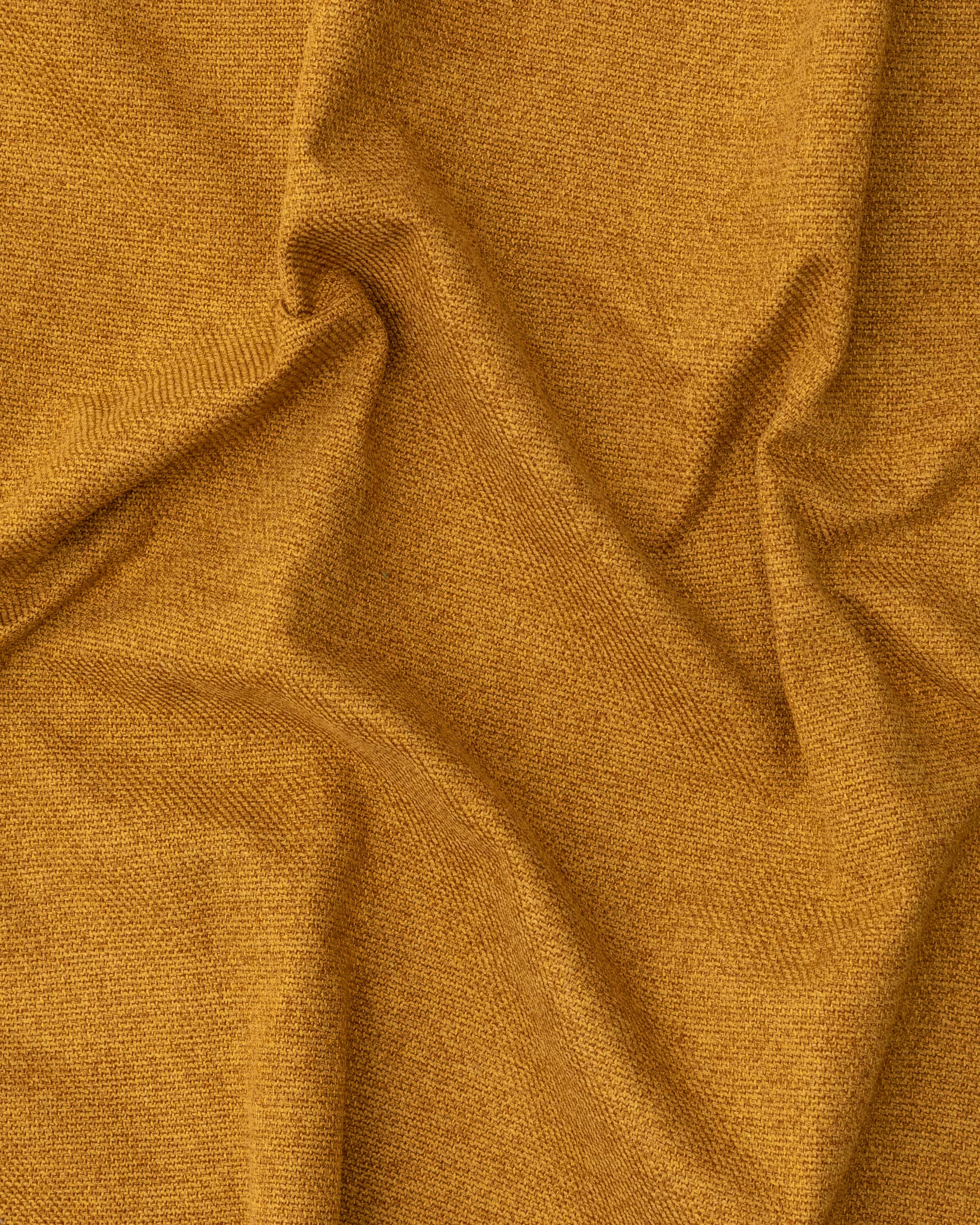 Close-up of textured mustard yellow fabric