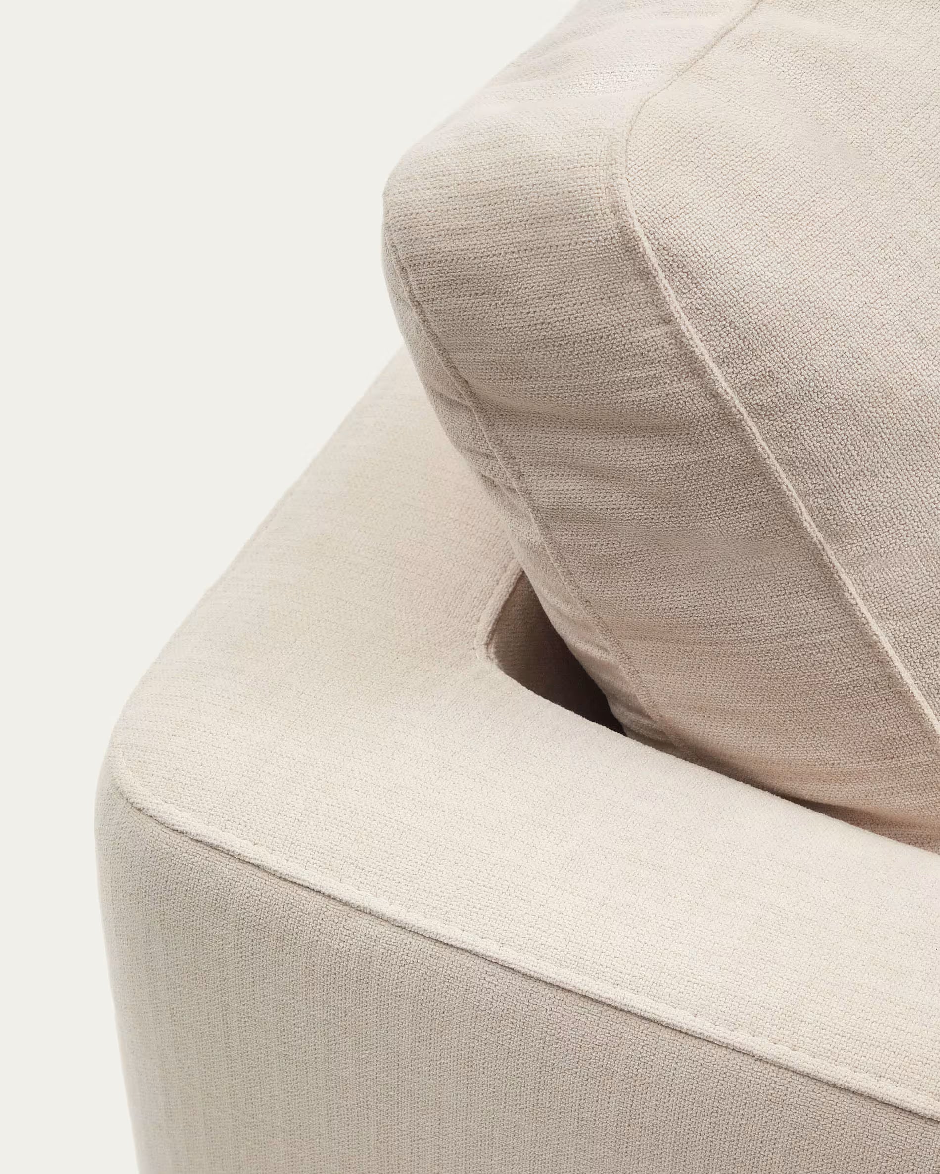 Close-up of a beige upholstered chair with a pillow on a white background