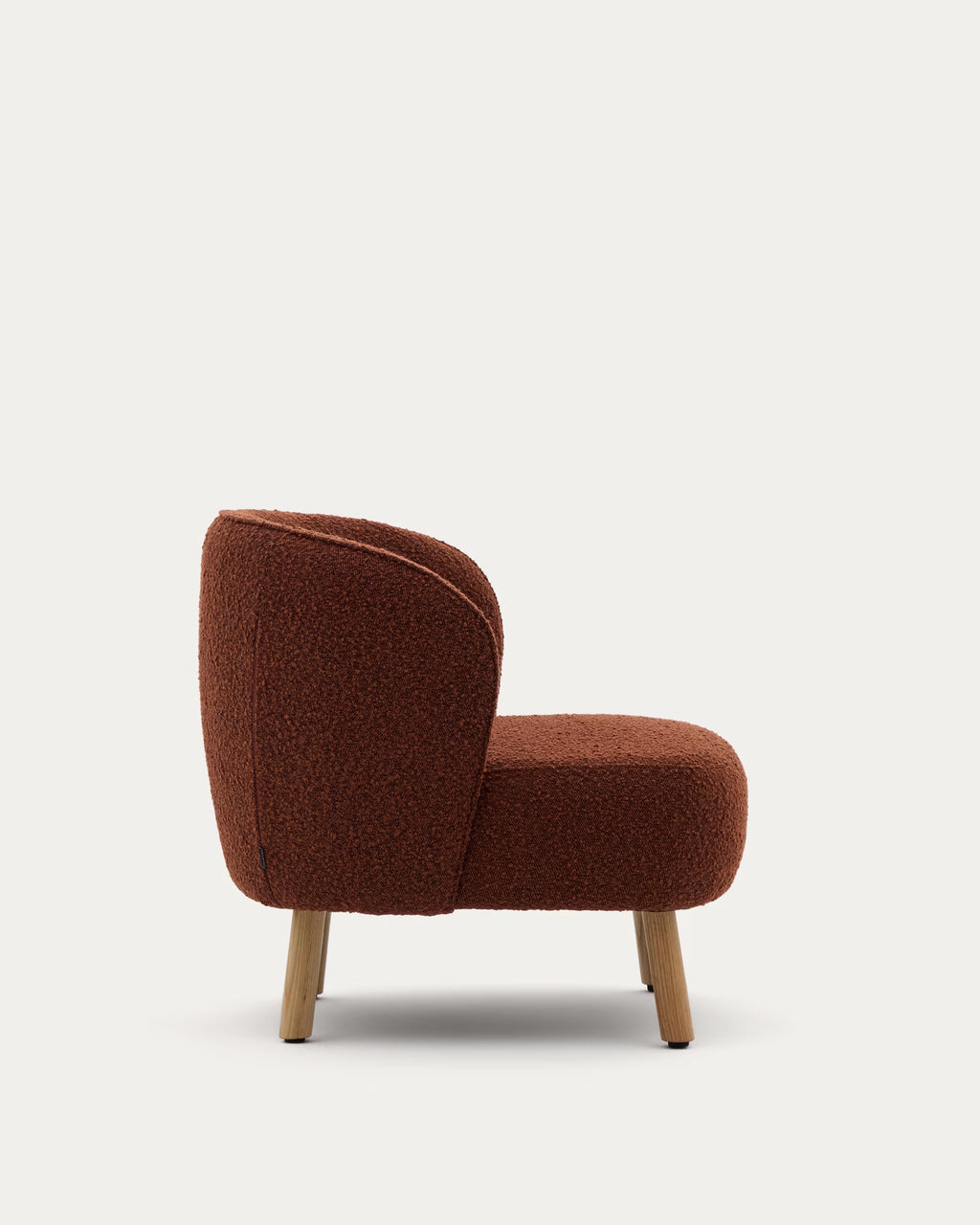 Brown upholstered chair with wooden legs on a white background