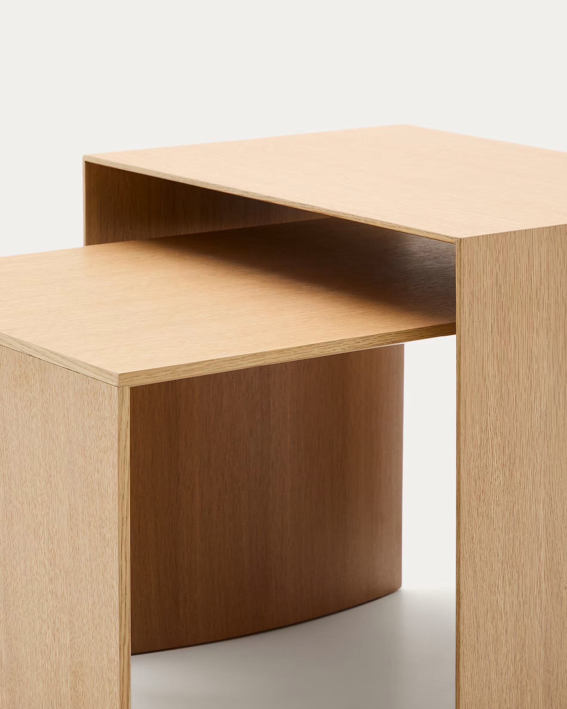 Two wooden nesting tables on a white background