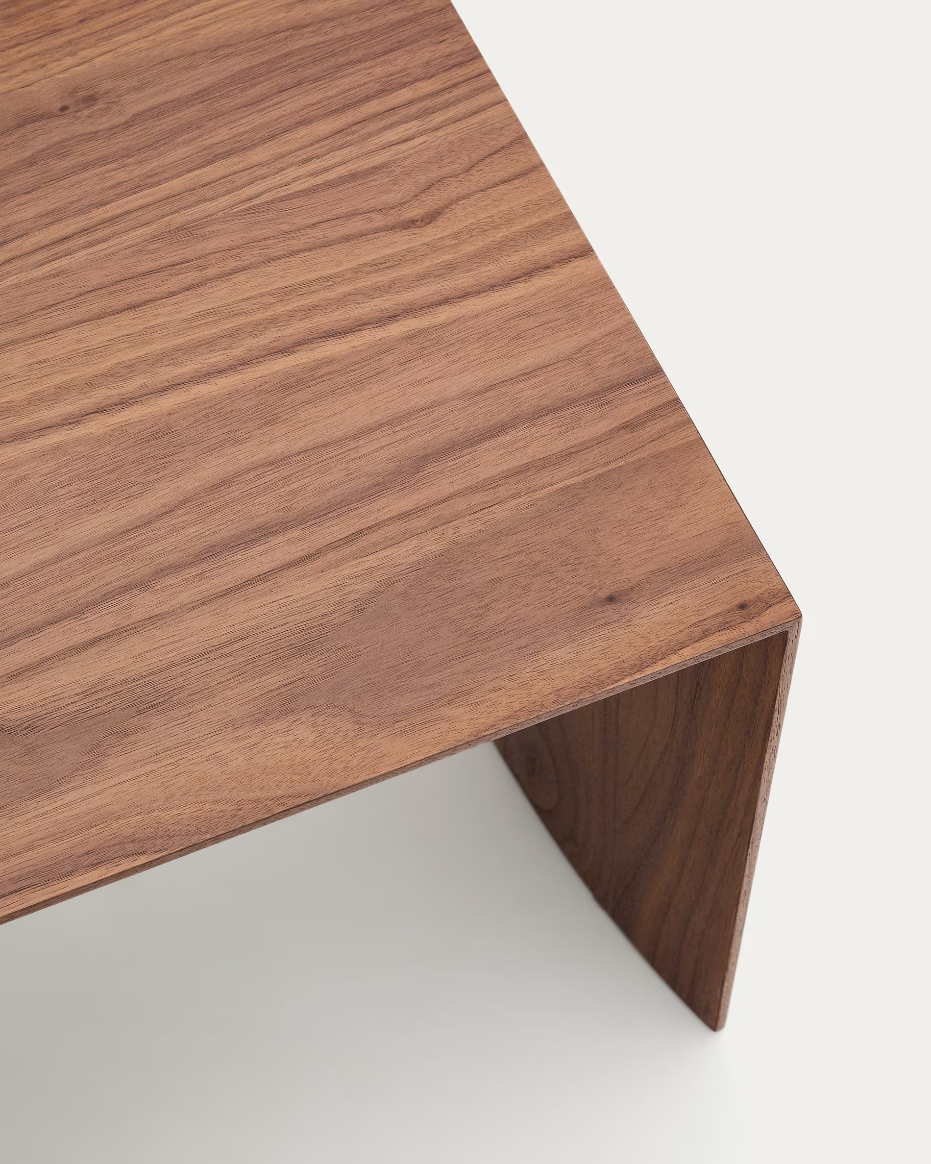 Close-up of a wooden desk corner on a white background