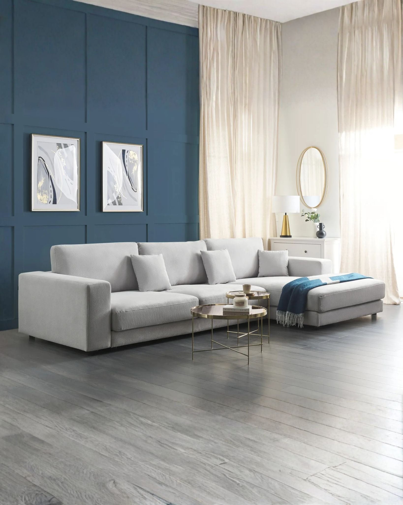 Modern living room with a gray sectional sofa, blue accent wall, and decorative elements.